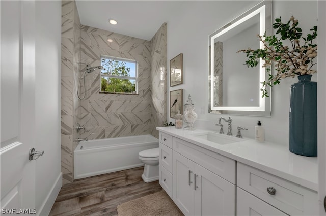 full bathroom featuring vanity, toilet, tiled shower / bath combo, and wood-type flooring