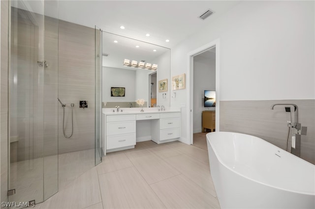 bathroom featuring vanity, tile walls, separate shower and tub, and tile patterned flooring