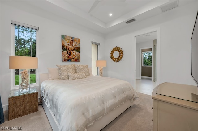 carpeted bedroom with multiple windows