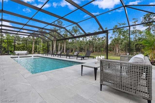 view of pool with a patio area and glass enclosure