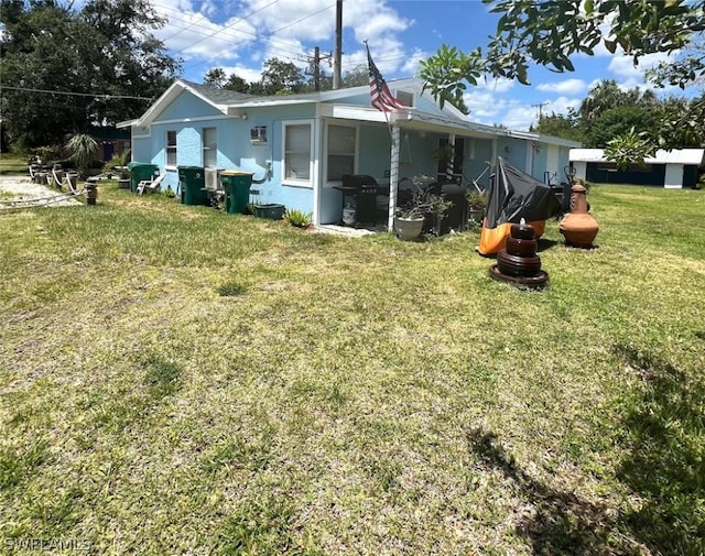 back of house featuring a yard