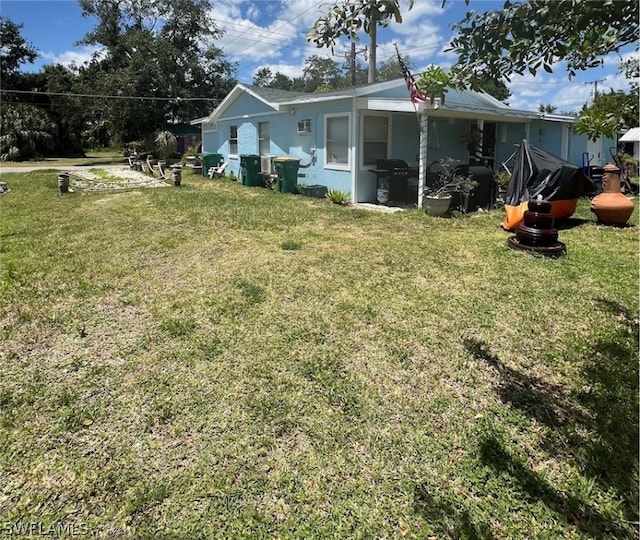 rear view of property with a yard