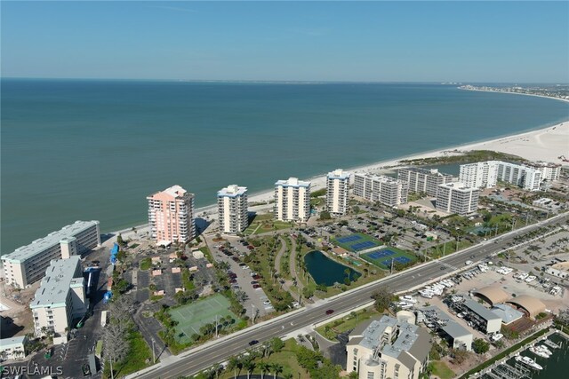 drone / aerial view with a beach view and a water view