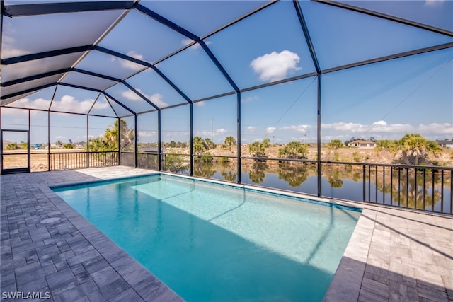 view of swimming pool featuring a patio area and a lanai