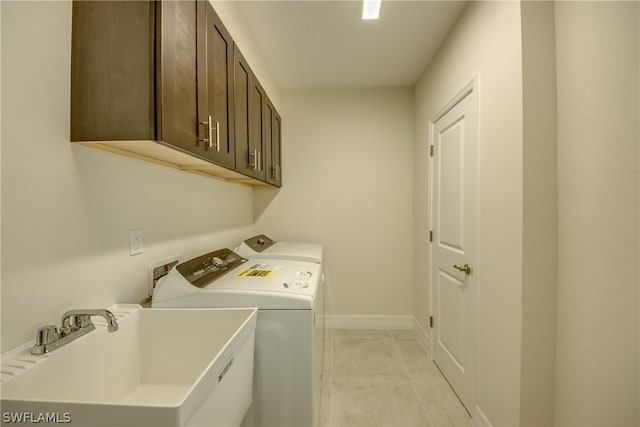 laundry area with cabinets, independent washer and dryer, washer hookup, sink, and light tile floors