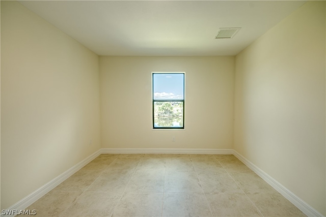 spare room with tile floors