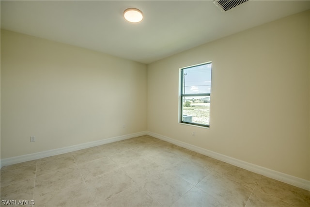 spare room featuring light tile floors