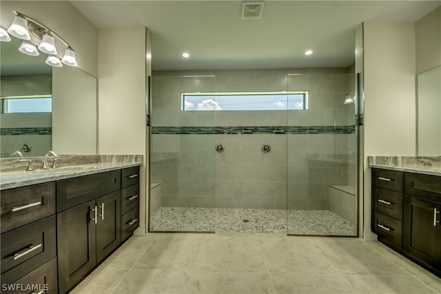 bathroom featuring an enclosed shower, tile flooring, and vanity