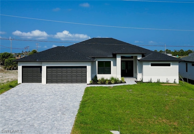 prairie-style house featuring a front lawn and a garage