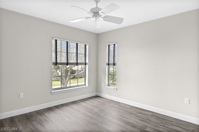 empty room featuring ceiling fan and dark wood-type flooring