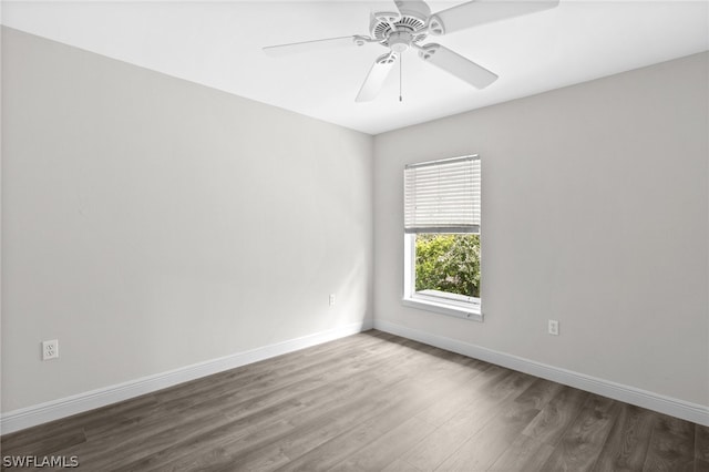 spare room with hardwood / wood-style floors and ceiling fan