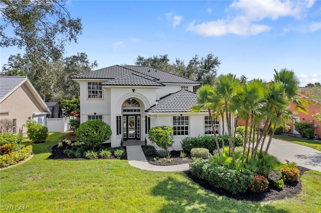 mediterranean / spanish home with a front yard