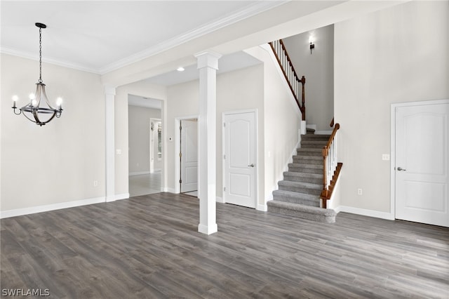 interior space with crown molding, ornate columns, dark hardwood / wood-style floors, and an inviting chandelier