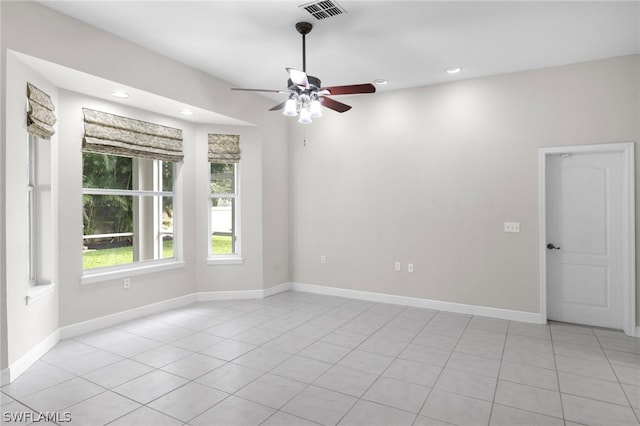 unfurnished room featuring ceiling fan and light tile floors