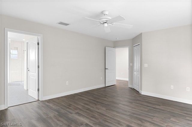 empty room featuring ceiling fan and dark wood-type flooring