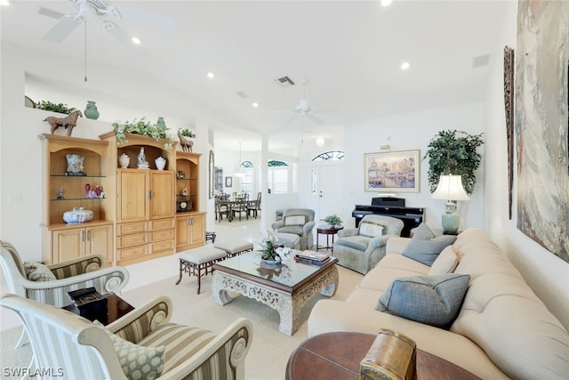 living room with ceiling fan, lofted ceiling, and light carpet