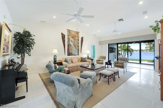 living room featuring ceiling fan, light tile patterned flooring, a water view, and lofted ceiling