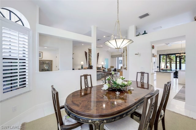 tiled dining room featuring ceiling fan