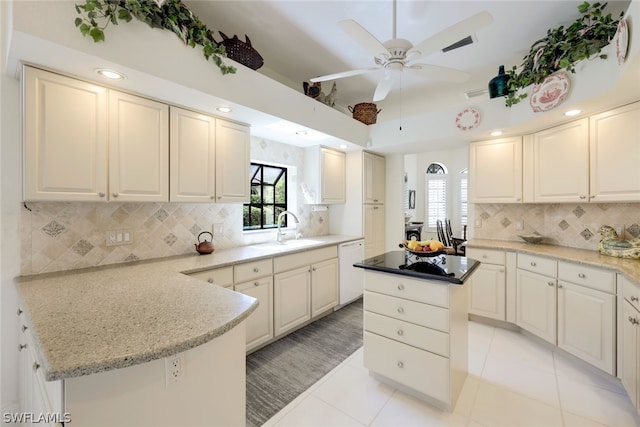 kitchen featuring dishwasher, a center island, light tile patterned floors, and sink