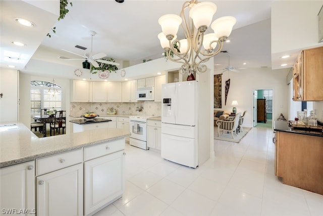 kitchen featuring light stone countertops, tasteful backsplash, ceiling fan with notable chandelier, white appliances, and white cabinetry