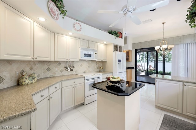 kitchen featuring tasteful backsplash, white cabinetry, a kitchen island, and white appliances