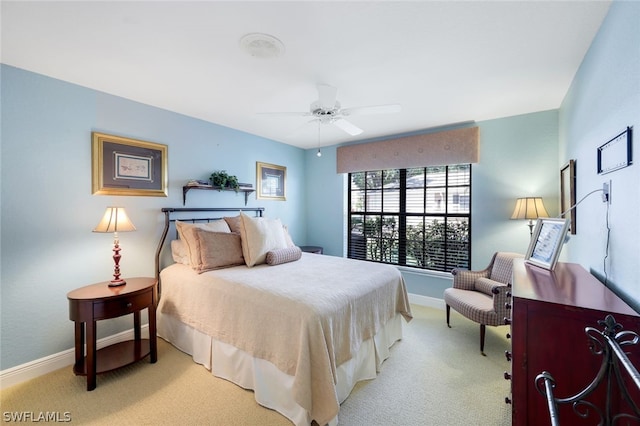 bedroom with ceiling fan and light carpet