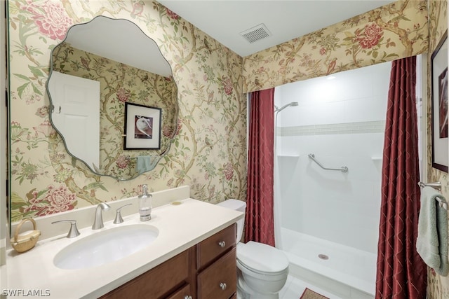 bathroom featuring vanity, curtained shower, and toilet