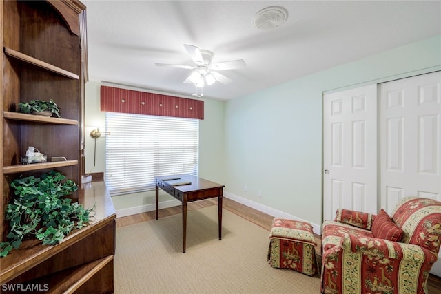 home office with ceiling fan and hardwood / wood-style floors