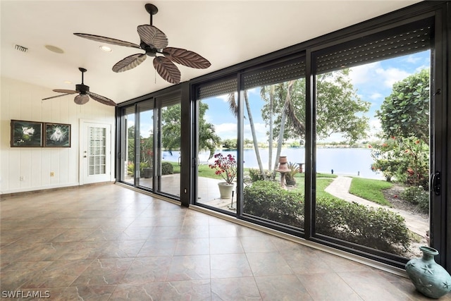 interior space with ceiling fan, a water view, and vaulted ceiling