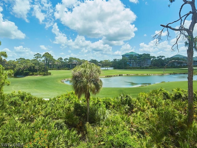 surrounding community featuring a water view and a lawn