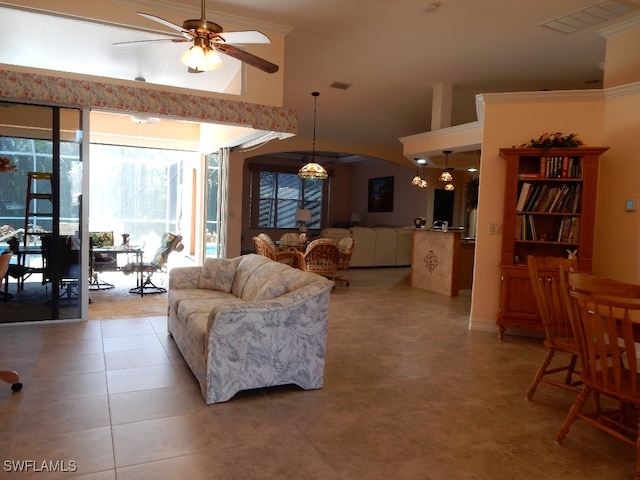 tiled living room with ceiling fan and ornamental molding