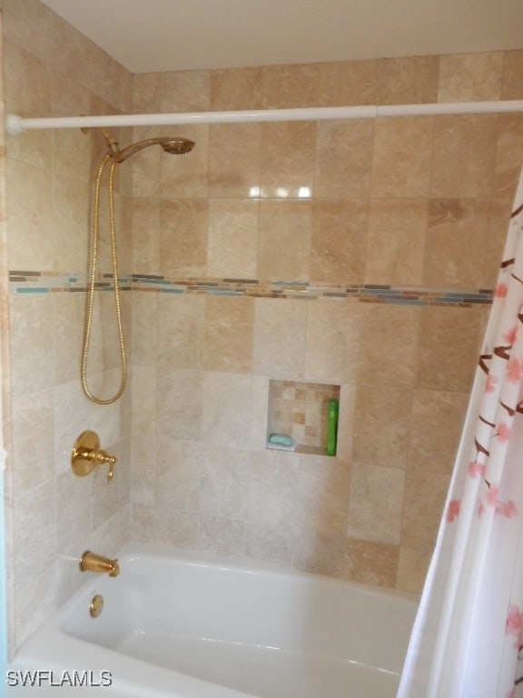 bathroom with shower / bath combo with shower curtain