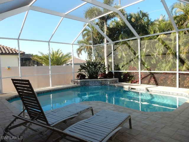 view of swimming pool with a lanai and a patio area