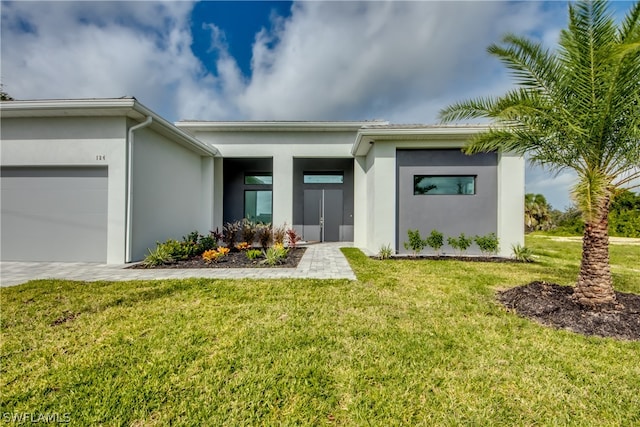 view of front of house featuring a garage and a front lawn