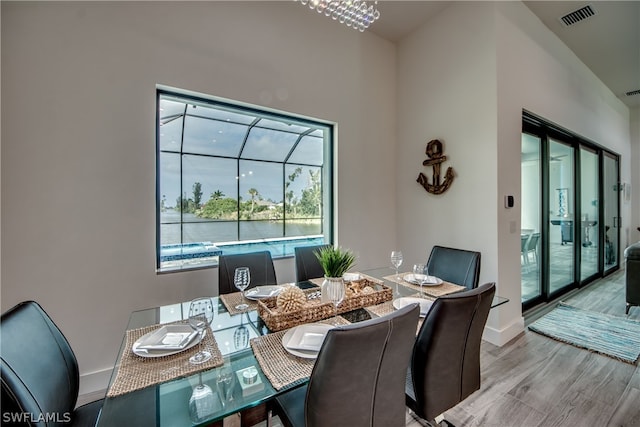 dining room featuring hardwood / wood-style floors and a chandelier