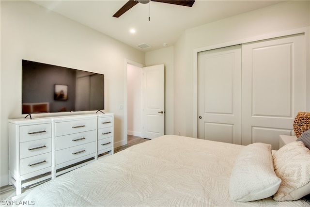 bedroom featuring a closet, wood-type flooring, and ceiling fan