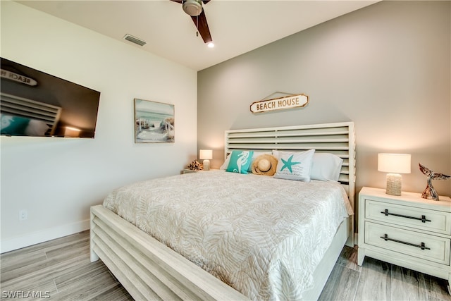 bedroom with ceiling fan and hardwood / wood-style flooring