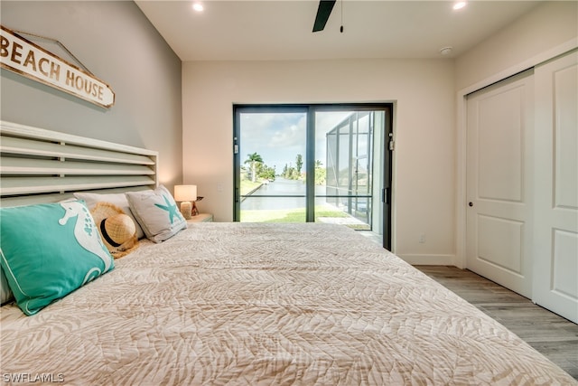 bedroom with a closet, ceiling fan, hardwood / wood-style flooring, and access to outside