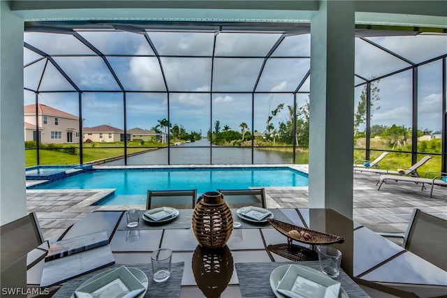 view of swimming pool featuring a lanai and a patio