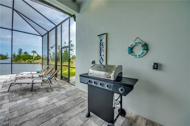 sunroom with vaulted ceiling and a water view