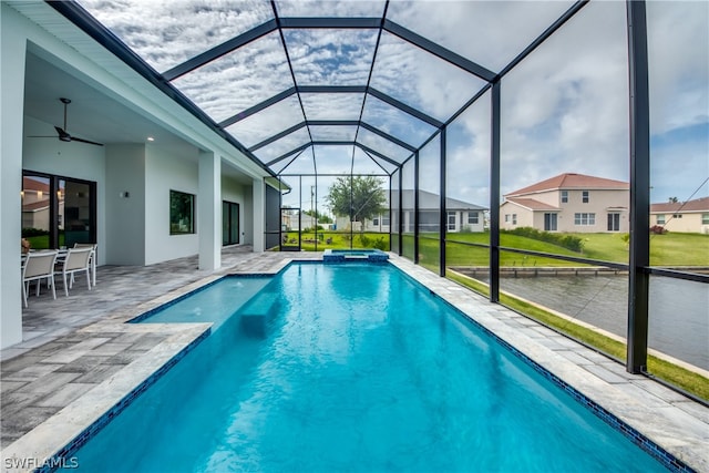 view of swimming pool featuring a patio area, a yard, a lanai, and ceiling fan