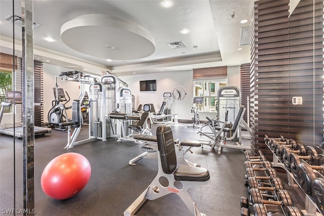 exercise room featuring a tray ceiling