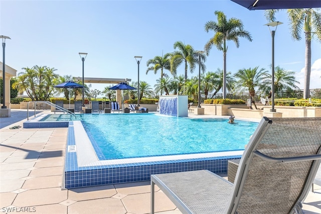 view of pool with a patio and pool water feature