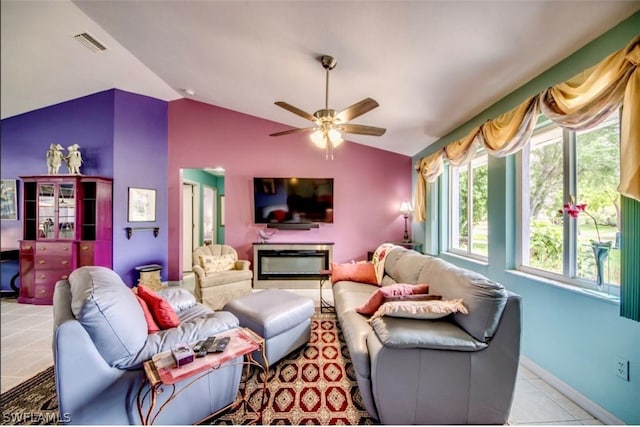 living room with ceiling fan, vaulted ceiling, and tile flooring