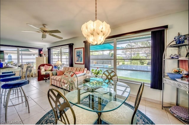 tiled dining space with a healthy amount of sunlight and ceiling fan