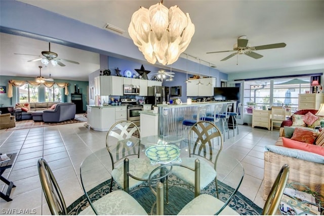 tiled dining area featuring ceiling fan and a wealth of natural light