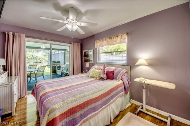 bedroom with hardwood / wood-style flooring, ceiling fan, access to exterior, and multiple windows