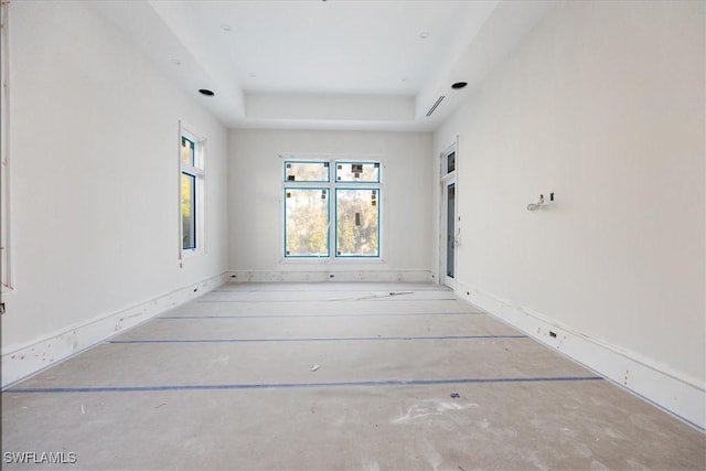 empty room featuring a tray ceiling