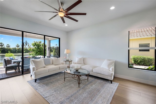 living room featuring ceiling fan and light wood-type flooring