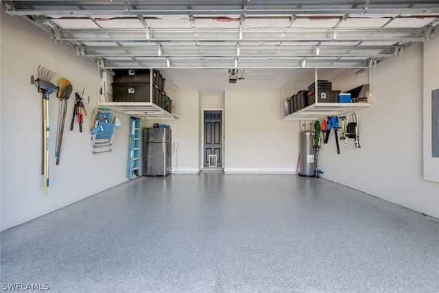 garage with water heater and stainless steel refrigerator